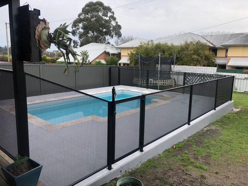 Pure Perf pool fence in Textured Black beside paving, Newcastle